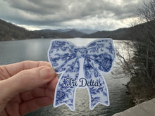 Load image into Gallery viewer, Sticker | DDD_E | Delta Delta Delta Toile Bow | Waterproof Vinyl Sticker | White | Permanent | Removable | Window Cling | Glitter | Holographic