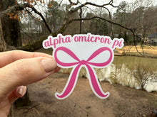 Load image into Gallery viewer, Sticker | AOP | Alpha Omicron PI Pink Bow | Waterproof Vinyl Sticker | White | Clear | Permanent | Removable | Window Cling | Glitter | Holographic