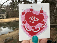 Load image into Gallery viewer, Sticker | ZTA_C | Zeta Tau Alpha Heart Shaped Cake | Waterproof Vinyl Sticker | White | Clear | Permanent | Removable | Window Cling | Glitter | Holographic