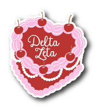 Load image into Gallery viewer, Sticker | DZ_C | Delta Zeta Heart Shaped Cake | Waterproof Vinyl Sticker | White | Clear | Permanent | Removable | Window Cling | Glitter | Holographic