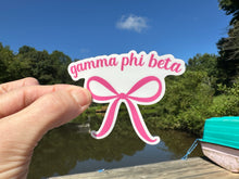 Load image into Gallery viewer, Sticker | GPhiB | Gamma Phi Beta Pink Bow | Waterproof Vinyl Sticker | White | Clear | Permanent | Removable | Window Cling | Glitter | Holographic