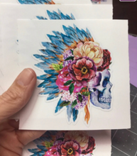 Load image into Gallery viewer, Sticker | 46B | Human Skull with Feather Headdress | Waterproof Vinyl Sticker | White | Clear | Permanent | Removable | Window Cling | Glitter | Holographic